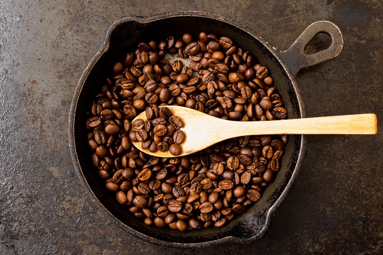 roasting coffee beans in a pan